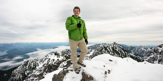 Standing on Springer with Stowe Peak, Johnstone Strait, and H'Kusam behind