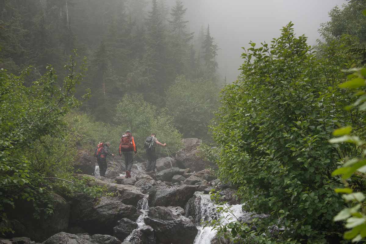 The four Island Mountain Ramblers walking up the stream toward Steamboat Mountain