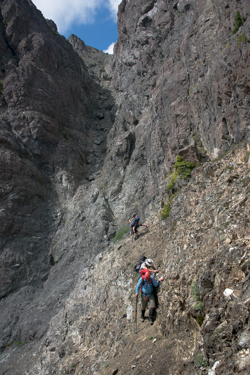 crossing the gravely ledge after descending the steep choss-filled gully.
