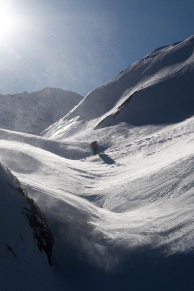 two figures walk into the wind on Adder Mountain