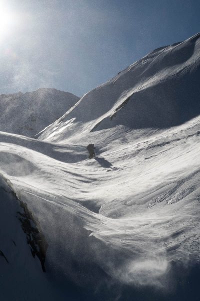 two figures walk into the wind on Adder Mountain