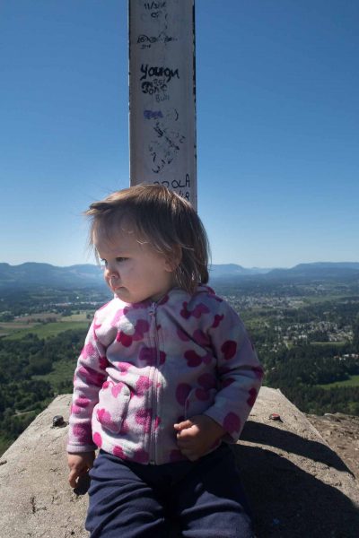 Octavia inspects the cliff edge at the cross on Mount Tzouhalem: What's down there?