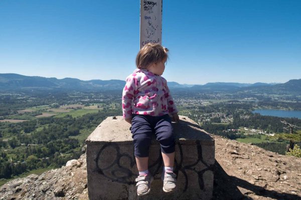 Octavia inspects the cliff edge at the cross on Mount Tzouhalem: What's down there?
